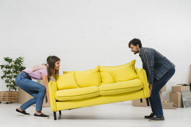 happy-young-couple-placing-yellow-sofa-living-room_23-2148095448
